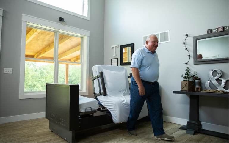Image of man walking away from ActiveCare Deluxe Hospital Bed.