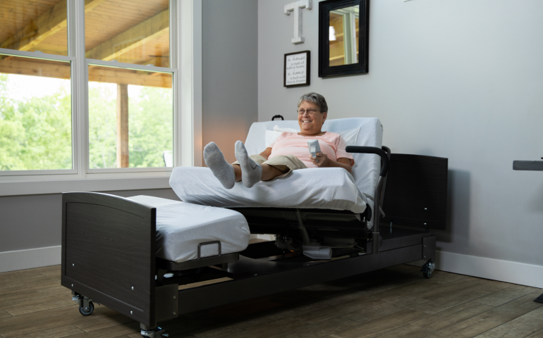 Image of woman laying on the ActiveCare Fixed Height Hospital Bed.