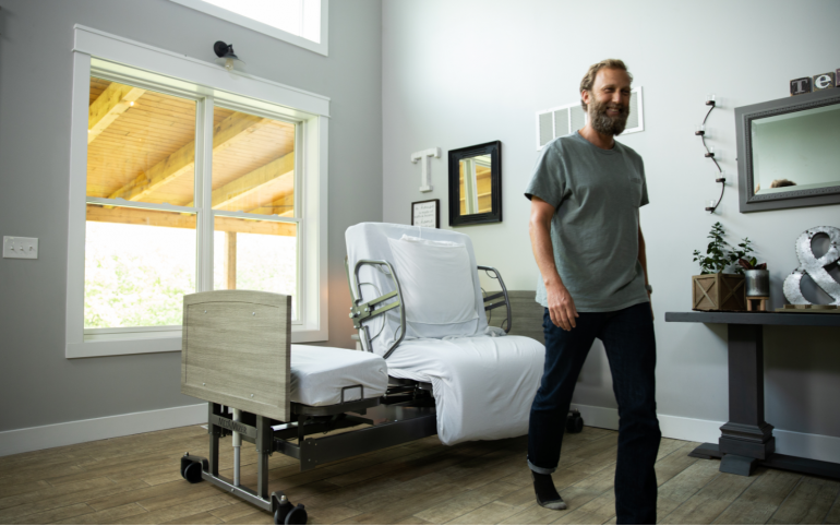 Image of the ActiveCare bed in the background rotated in a room.