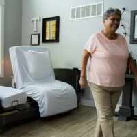 ActiveCare Fixed Height Hospital Bed 6 thumbnail Image of the ActiveCare Fixed Height Bed and woman walking away from it. thumbnail