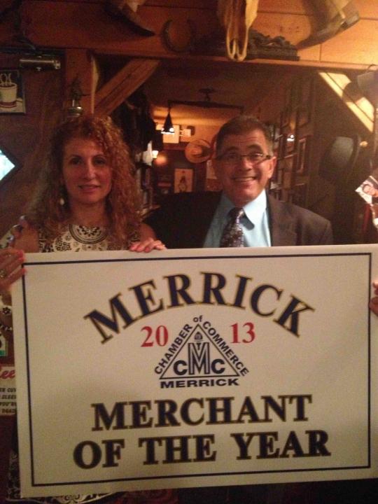 Photo featuring Leo Levine and Andra Levine, owners of Merrick Surgical, holding up an award sign.